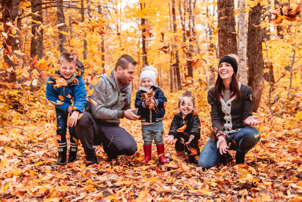 Family taking photos outside in the fall