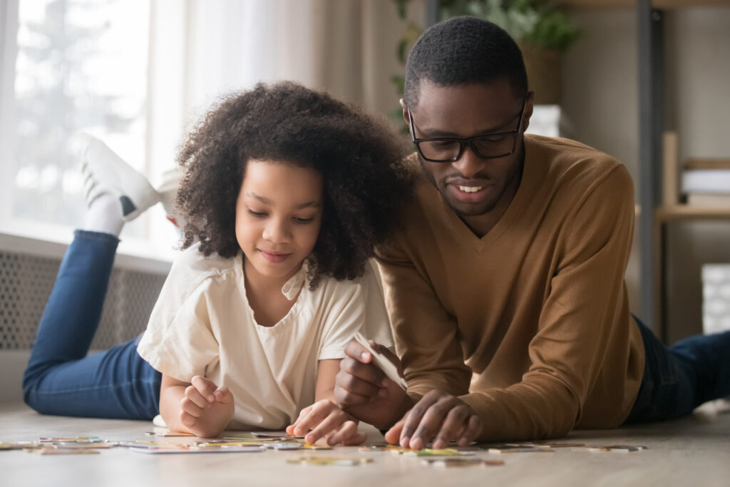Dad playing puzzle with child