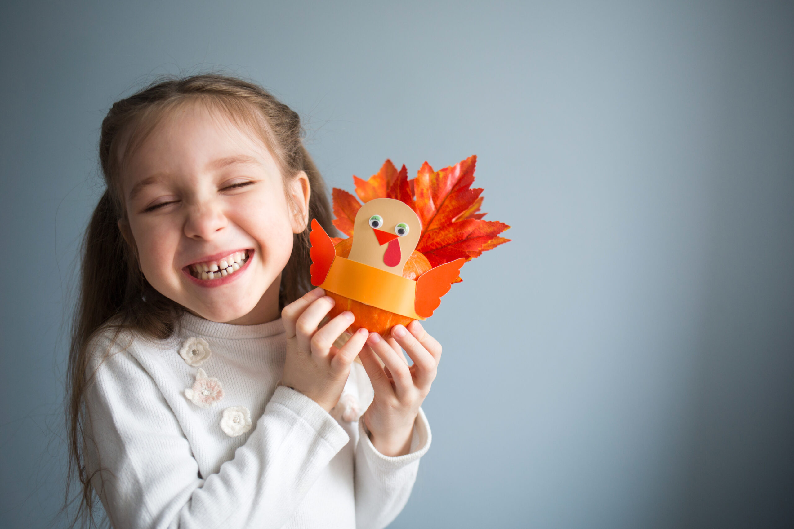 Child with Thansgiving Craft