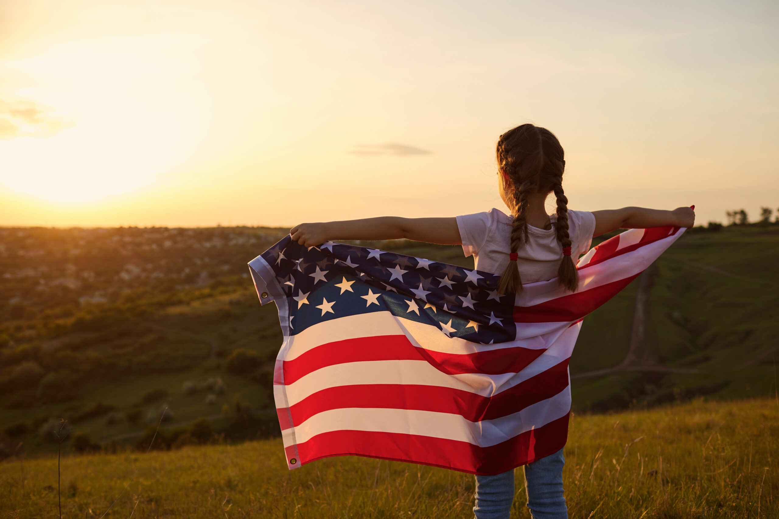 Girl holding a flag of the USA