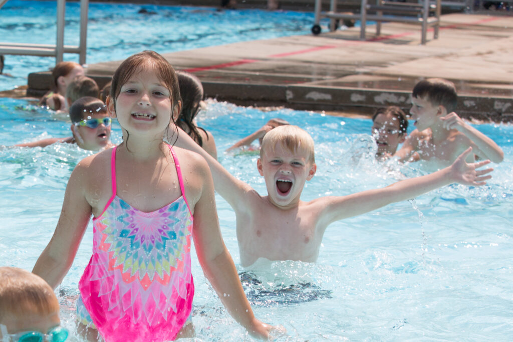 Two kids swimming in Kuehn Pool