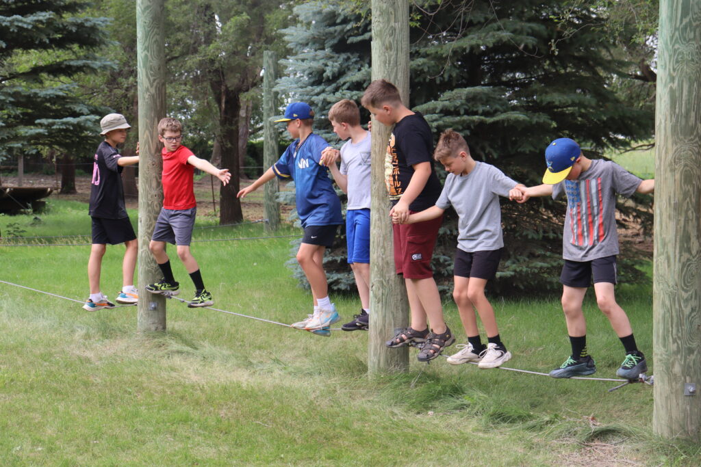 Boys working on teamwork at camp leif ericson