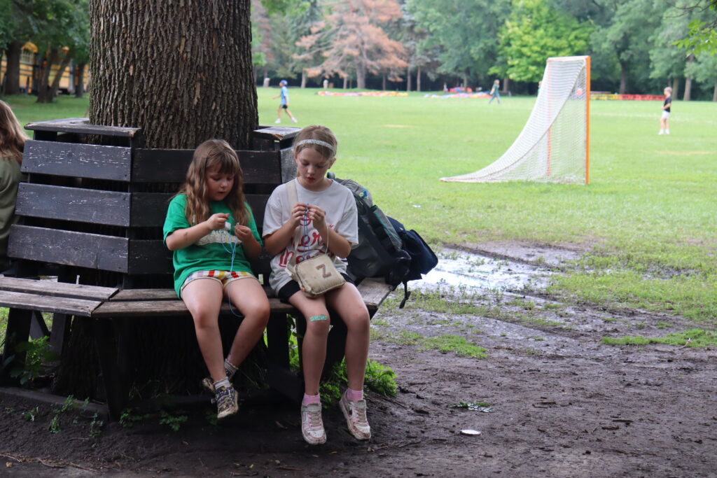 Two girls work on crafts at camp leif ericson