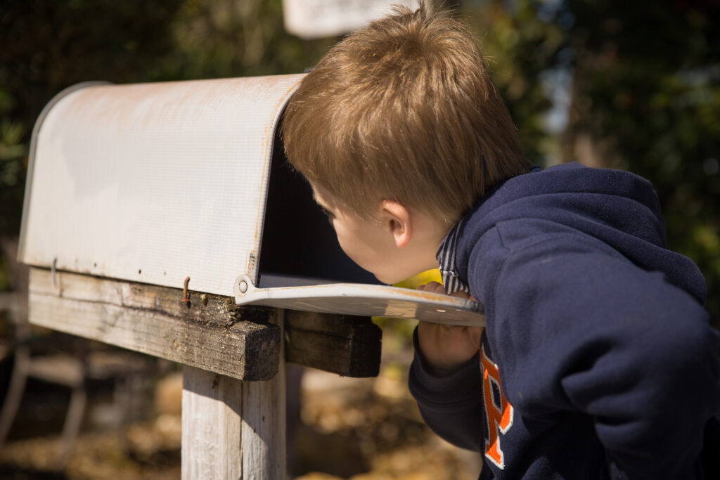 Kid looking into the mailbox